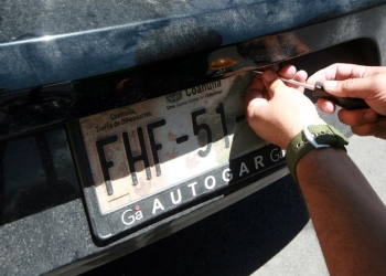 Portar placas sobrepuestas no es delito grave